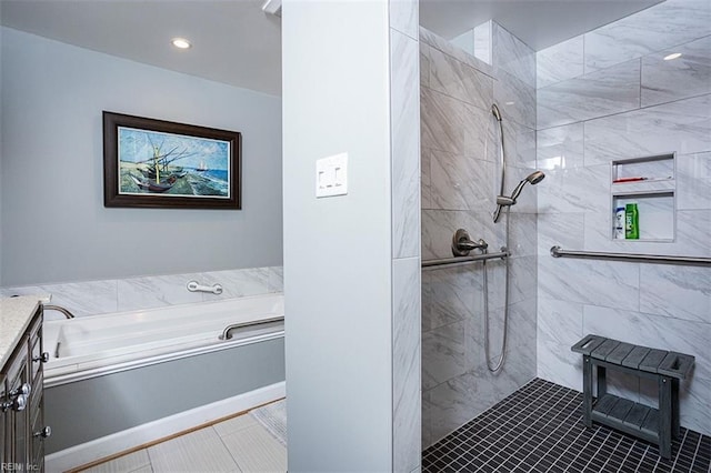 bathroom featuring tiled shower, a garden tub, and vanity