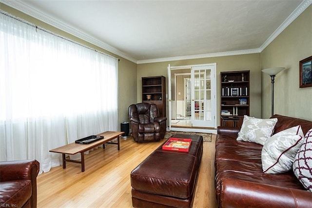 living area with ornamental molding and wood finished floors