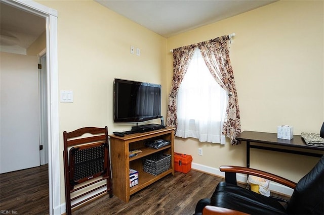 living area featuring wood finished floors and baseboards