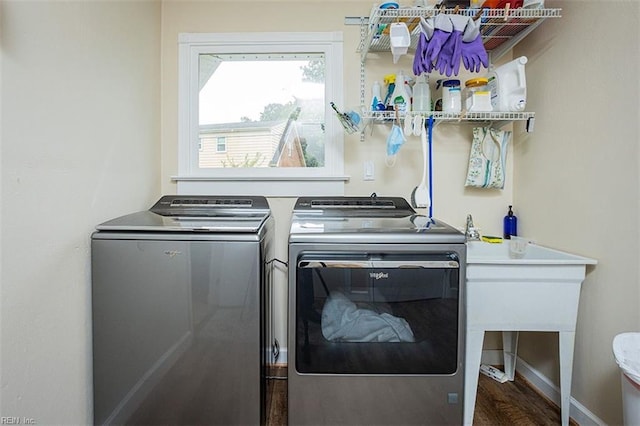 clothes washing area featuring washer and dryer, laundry area, and baseboards