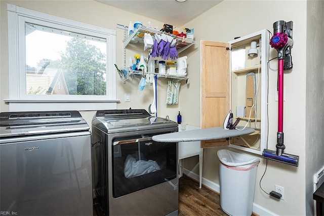 laundry area with laundry area, independent washer and dryer, wood finished floors, and baseboards