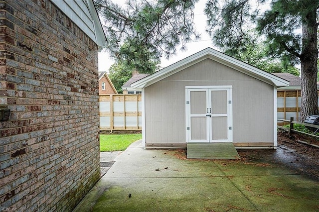 view of shed with fence