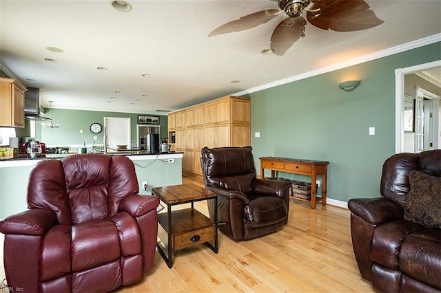 living room with light wood finished floors, a ceiling fan, baseboards, and crown molding