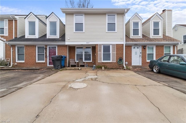 townhome / multi-family property with brick siding