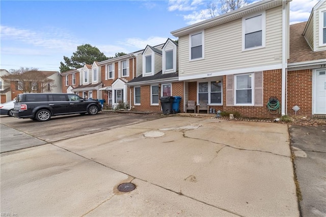 multi unit property with a residential view and brick siding