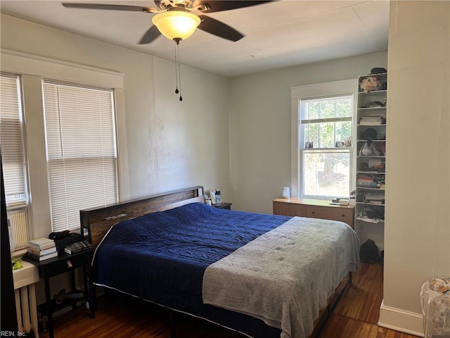 bedroom with ceiling fan and wood finished floors