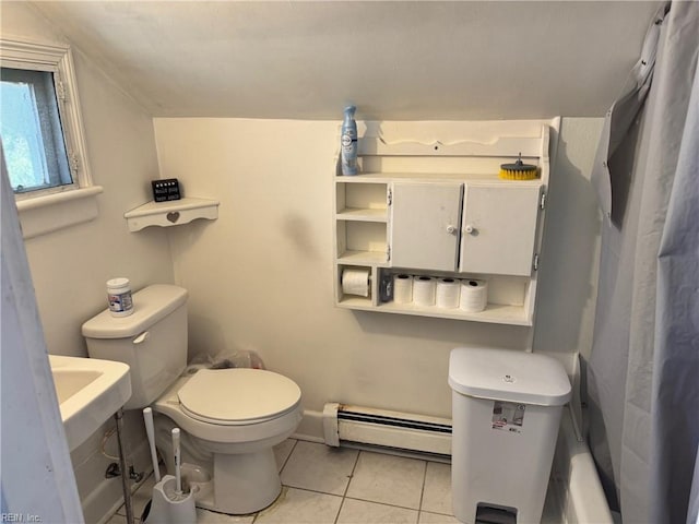 full bathroom with a baseboard heating unit, tile patterned flooring, and toilet