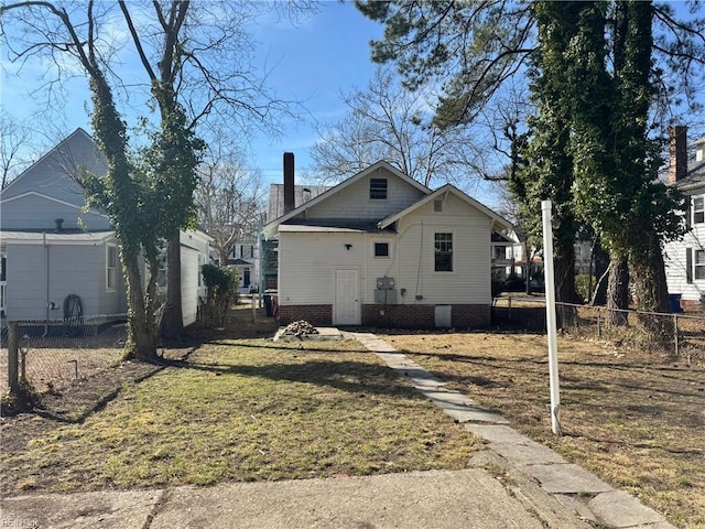 view of front facade featuring a front yard, fence, and a chimney