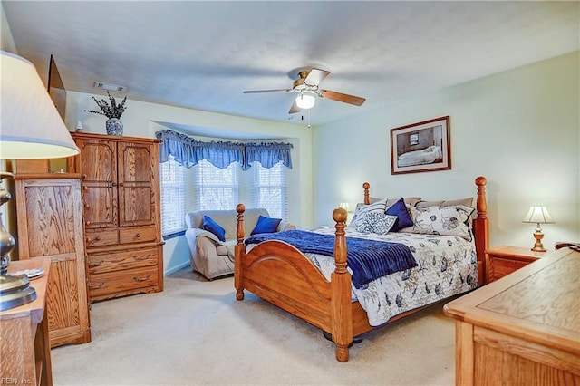 bedroom featuring light carpet, ceiling fan, and visible vents