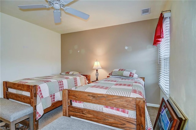 bedroom with ceiling fan, carpet floors, visible vents, and baseboards