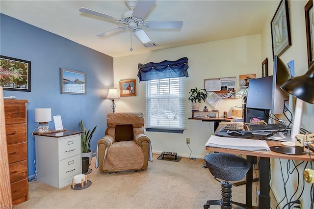 carpeted home office featuring baseboards, visible vents, and a ceiling fan