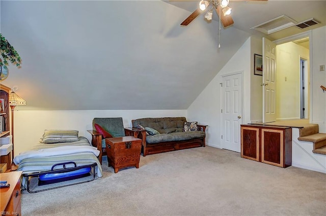 interior space featuring attic access, visible vents, vaulted ceiling, and carpet flooring