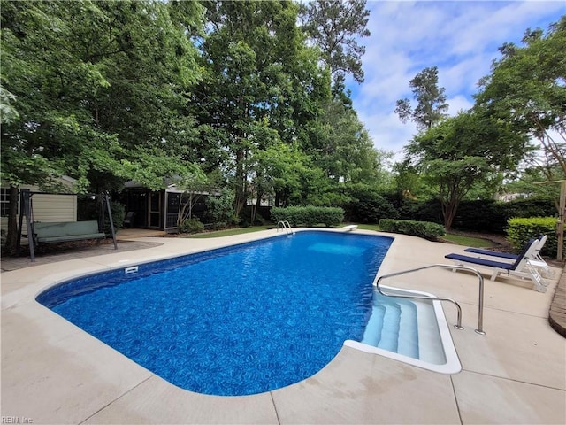 outdoor pool with a patio area