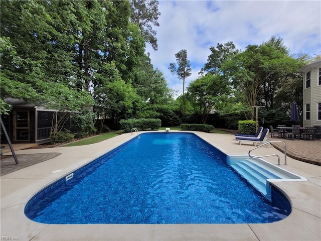 outdoor pool with a patio area