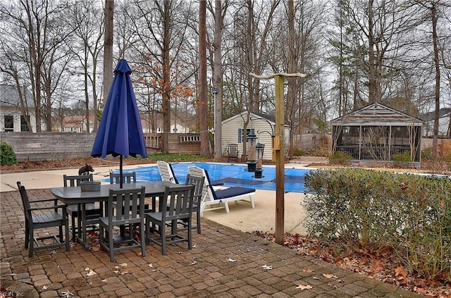 view of pool featuring a fenced backyard, outdoor dining area, and a gazebo