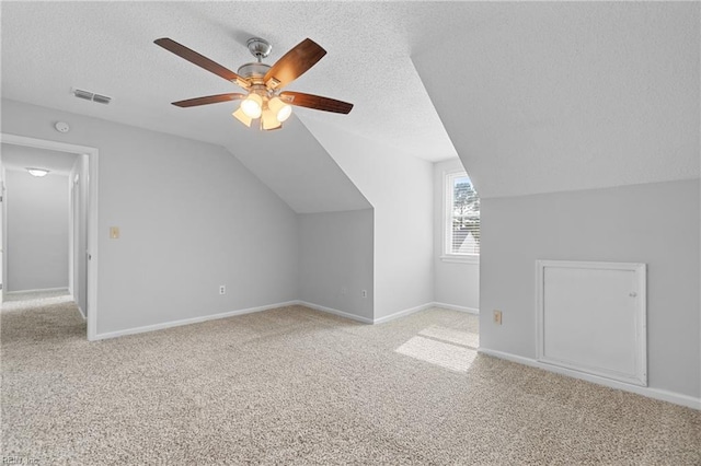 additional living space featuring light carpet, baseboards, and vaulted ceiling