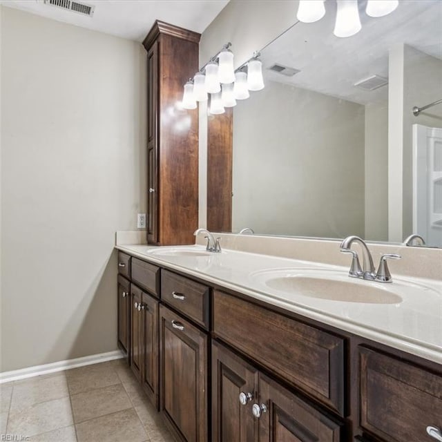 full bath featuring visible vents, a sink, baseboards, and double vanity