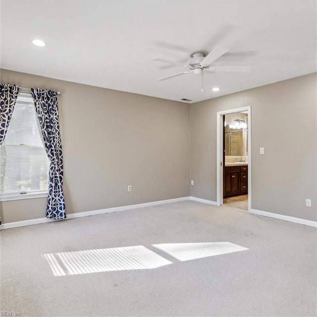 unfurnished room featuring a ceiling fan, recessed lighting, light colored carpet, and baseboards