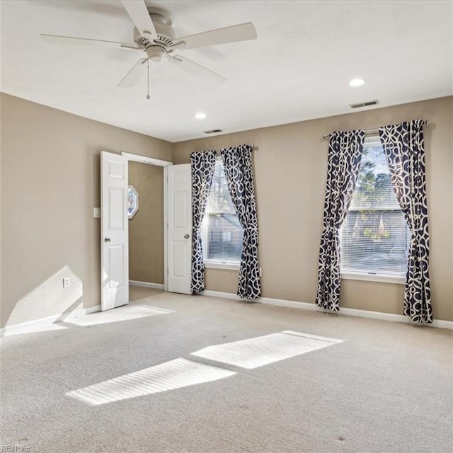 unfurnished room with recessed lighting, visible vents, carpet flooring, ceiling fan, and baseboards