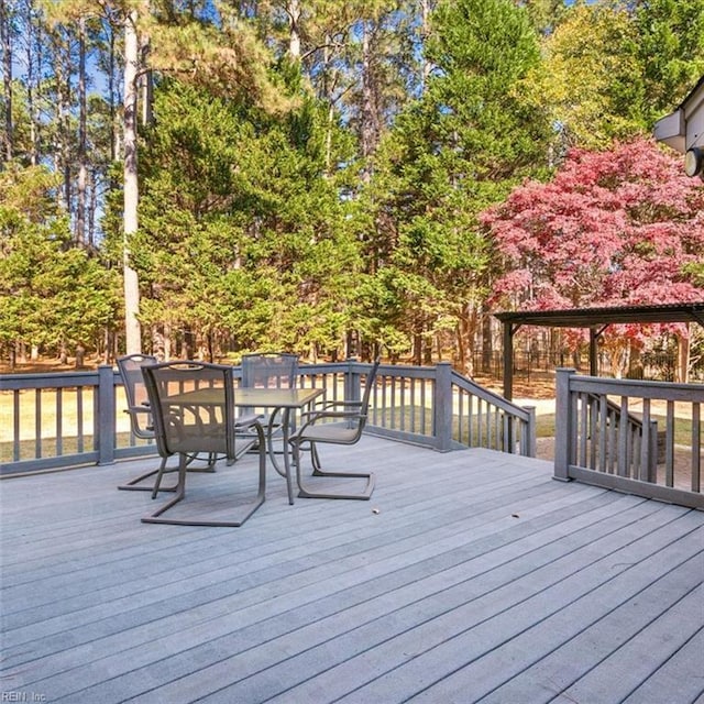 wooden deck featuring outdoor dining area