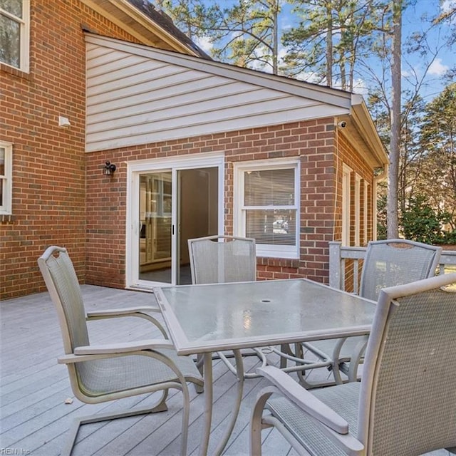 wooden terrace featuring outdoor dining area