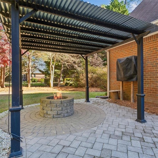 view of patio with a fire pit, fence, and a pergola