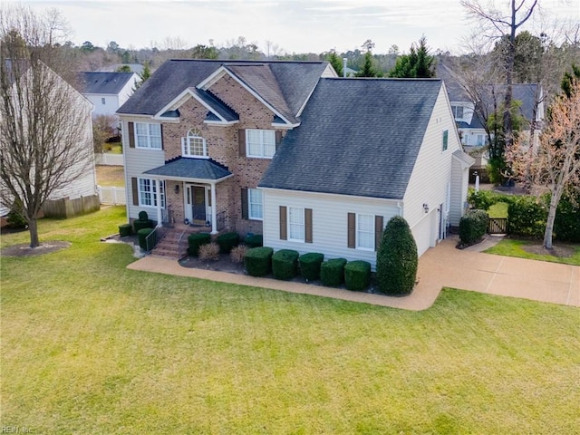 view of front of home featuring concrete driveway, a shingled roof, a front yard, and fence