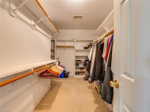 walk in closet with carpet floors and visible vents