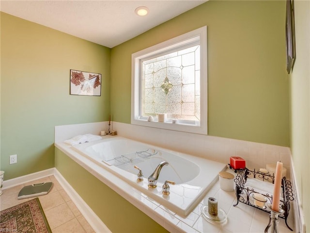 full bathroom with a garden tub, baseboards, and tile patterned floors