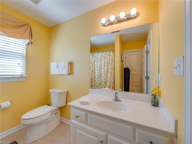 bathroom with baseboards, vanity, toilet, and tile patterned floors