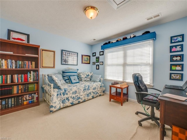 office space with baseboards, carpet, visible vents, and a textured ceiling