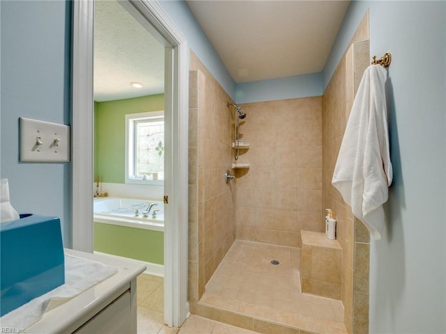 bathroom with tile patterned flooring, tiled shower, a garden tub, and a textured ceiling