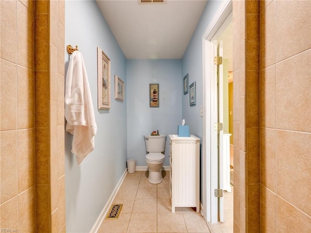 bathroom with baseboards, visible vents, toilet, and tile patterned floors