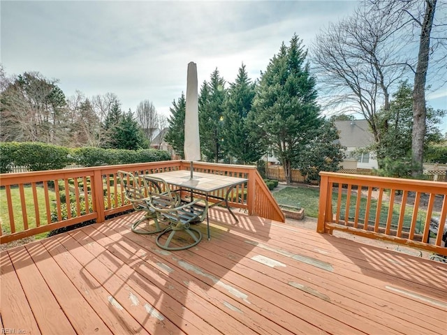 wooden terrace with a lawn and fence