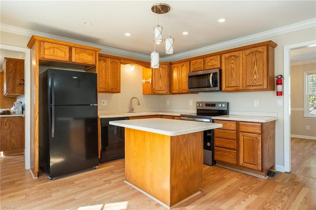 kitchen featuring ornamental molding, light wood-type flooring, light countertops, and black appliances