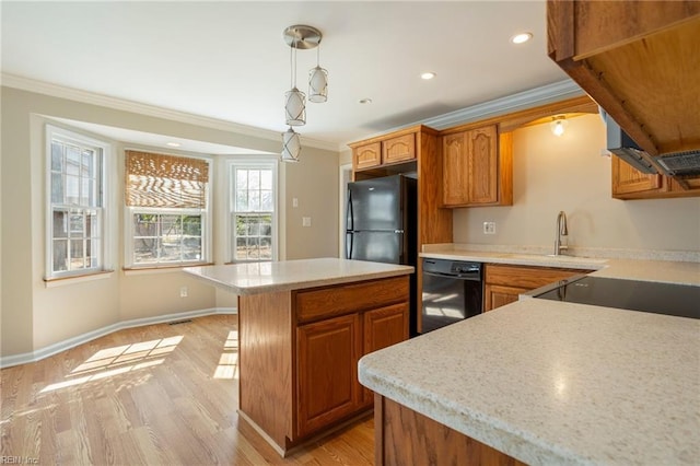 kitchen with brown cabinetry, ornamental molding, light wood-style flooring, and black appliances