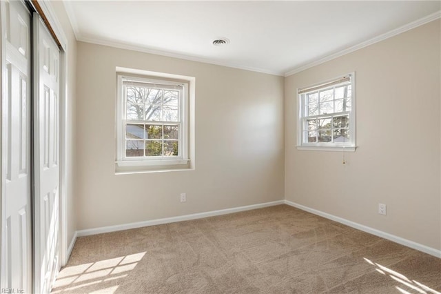 unfurnished bedroom featuring ornamental molding, carpet, a closet, and multiple windows