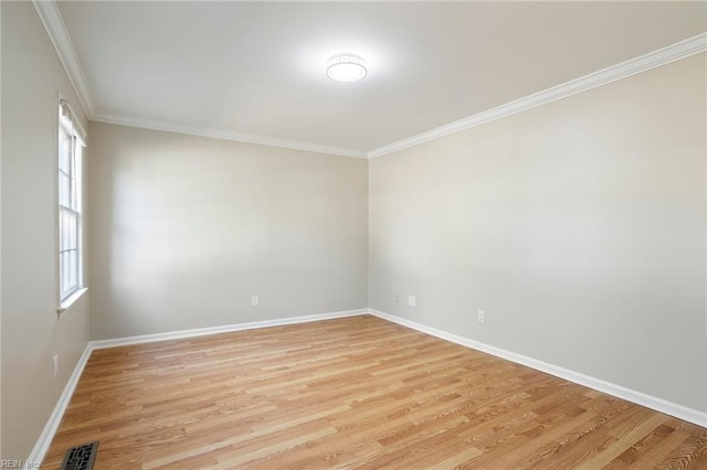 empty room with light wood-style floors, baseboards, visible vents, and ornamental molding