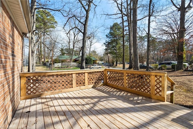 wooden terrace featuring fence