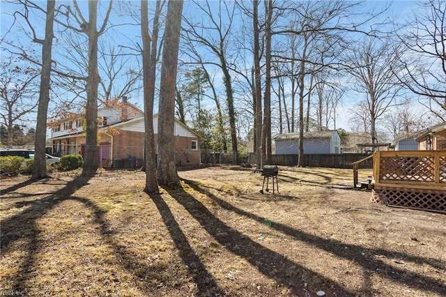 view of yard with a fenced backyard and a wooden deck