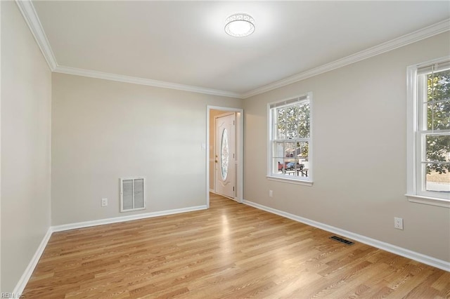 unfurnished room with light wood-style floors, a healthy amount of sunlight, and visible vents