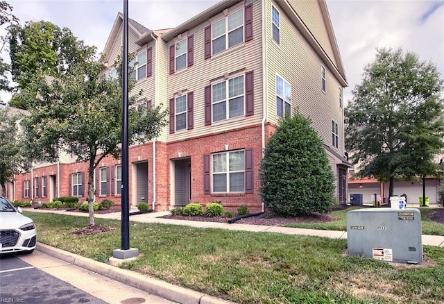 view of front of house with brick siding and a front yard