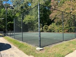 view of sport court featuring fence