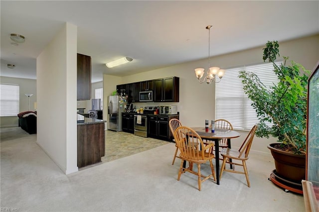 dining room featuring plenty of natural light and a notable chandelier