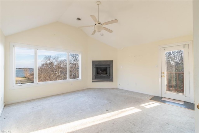 unfurnished living room featuring a fireplace, visible vents, a wealth of natural light, and carpet flooring