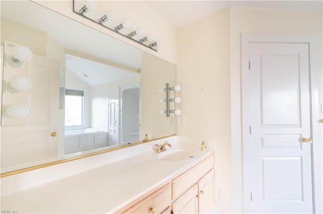 bathroom featuring vaulted ceiling and vanity