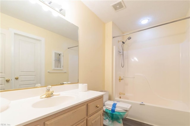 bathroom featuring toilet, shower / tub combination, vanity, and visible vents