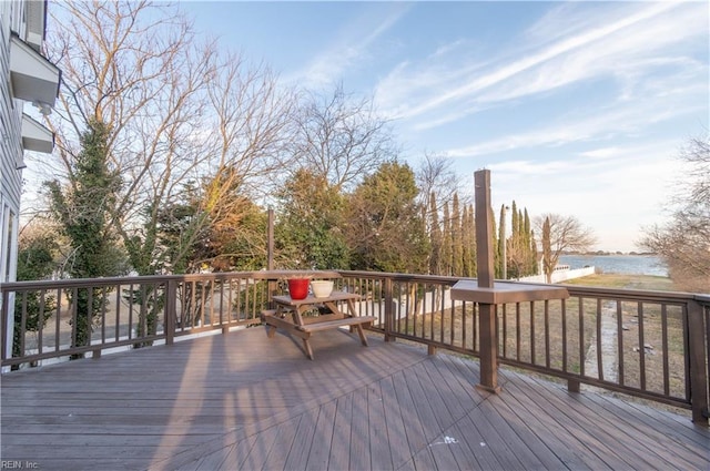 wooden terrace featuring a water view