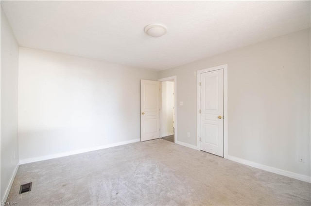 unfurnished room featuring carpet floors, baseboards, and visible vents