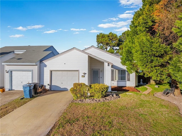 view of front of house featuring concrete driveway, an attached garage, and a front yard